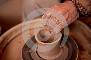 Potter`s hands work with clay