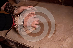 Potter`s hands work with clay