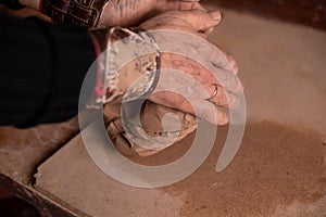 Potter`s hands work with clay