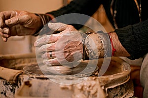 Potter`s hands work with clay