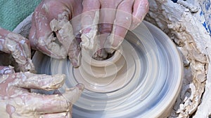 Potter`s Hands Work with Clay on a Potter`s Wheel