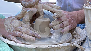 Potter`s Hands Work with Clay on a Potter`s Wheel