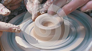 Potter`s Hands Work with Clay on a Potter`s Wheel