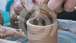 Potter`s Hands Work with Clay on a Potter`s Wheel. Slow Motion