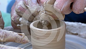 Potter`s Hands Work with Clay Vase on a Potter`s Wheel. Slow Motion