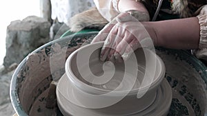 Potter`s hands at work, creating a bowl