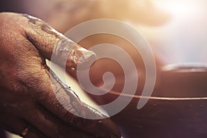 Potter`s hands while working at potter`s wheel