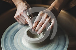 Potter's hands working with raw clay