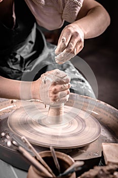 Potter& x27;s wheel and potter& x27;s hands. Close-up.