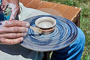 On the potter`s wheel revolve a spinning of a clay cup