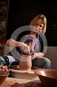 Potter shaping clay
