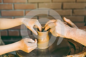 Potter teaches to sculpt a clay pot