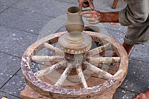 Potter using traditional wheel