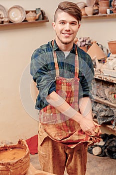 Potter washes his hands in clay studio