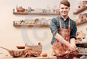Potter washes his hands in clay studio