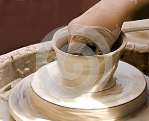 Potter at work on clay pot