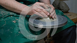 Potter at work. Hands of potter do a clay pot