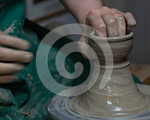 Potter at work. Hands of potter do a clay pot