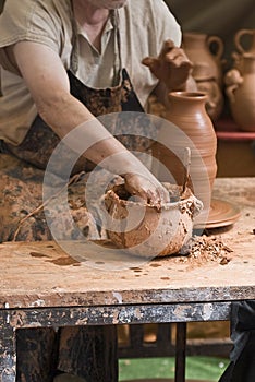 Potter working on the lathe.