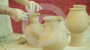 Potter works. Crockery creation process in pottery on potters wheel