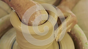 Potter works. Crockery creation process in pottery on potters wheel