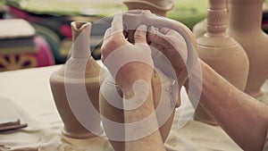 Potter works. Crockery creation process in pottery on potters wheel