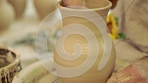 Potter works. Crockery creation process in pottery on potters wheel