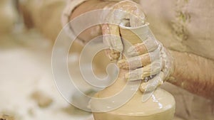 Potter works. Crockery creation process in pottery on potters wheel