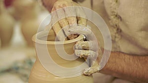 Potter works. Crockery creation process in pottery on potters wheel