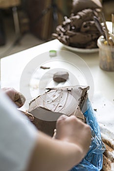 Pottering Concept. Hands of Professional Ceramist During a Process of Clay Preparation With Wires on Table in Workshop