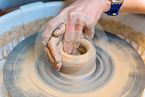 Pottering - creating a clay cup in process