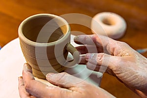 Pottering - creating a clay cup in process