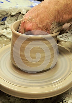 Potters hand in pot