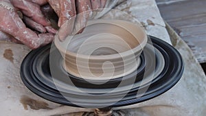 Potters makes plate of clay