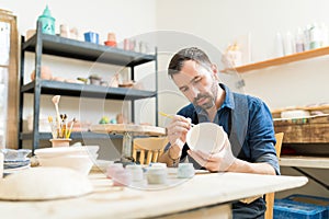 Pottery Expert Painting Bowl Made Of Clay