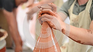 Pottery girl enjoying pottery art and production process. Hand work. Close-up.