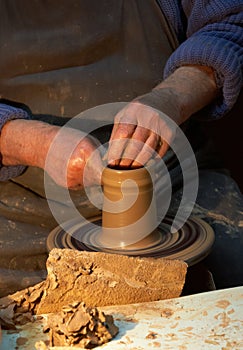 Pottery. Hands of a potter who makes a jug of clay.Craft
