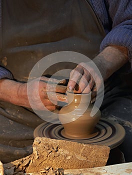 Pottery. Hands of a potter who makes a jug of clay.Craft