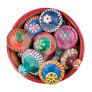 Pottery lids stacked in a pottery bowl on white background