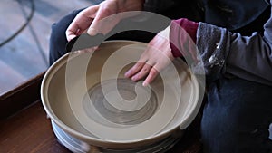 Pottery polishing process with 2 hands in the final step.