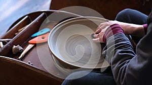 Pottery polishing process with 2 hands in the final step.