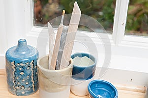 Pottery tools and vases on a window ledge