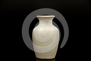 Pottery, vase, jug of white clay isolated on a black background. Pottery mockup made of white clay on a black background. Layout f