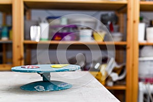 Pottery wheel with ceramics tools for making art and craft objects from clay in a workshop studio