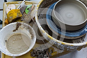 Pottery wheel with ceramics tools for making art and craft objects from clay in a workshop studio