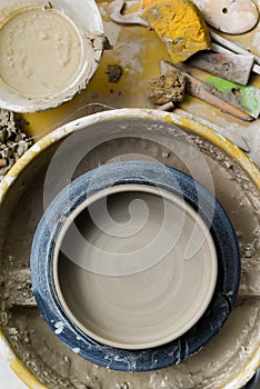 Pottery wheel with ceramics tools for making art and craft objects from clay in a workshop studio