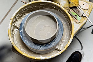 Pottery wheel with ceramics tools for making art and craft objects from clay in a workshop studio