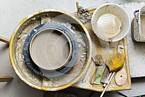 Pottery wheel with ceramics tools for making art and craft objects from clay in a workshop studio