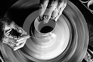 Pottery wheel with potter`s hands .