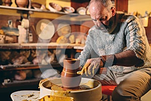 Pottery workshop. A senior man makes a vase of clay. Clay modeling